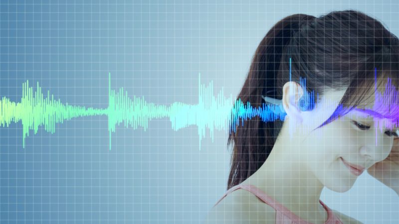 young woman wearing open-ear headphones