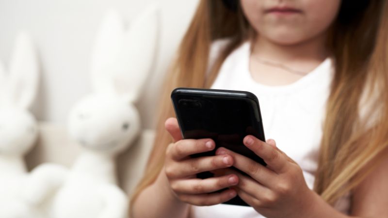 child scrolling phone